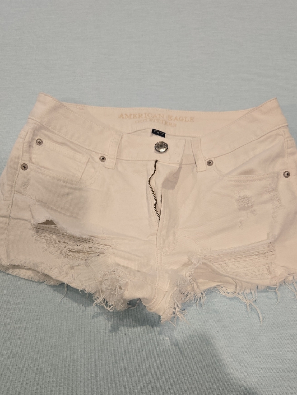 American Eagle Outfitters Cream Distressed Denim Cutoff Shorts